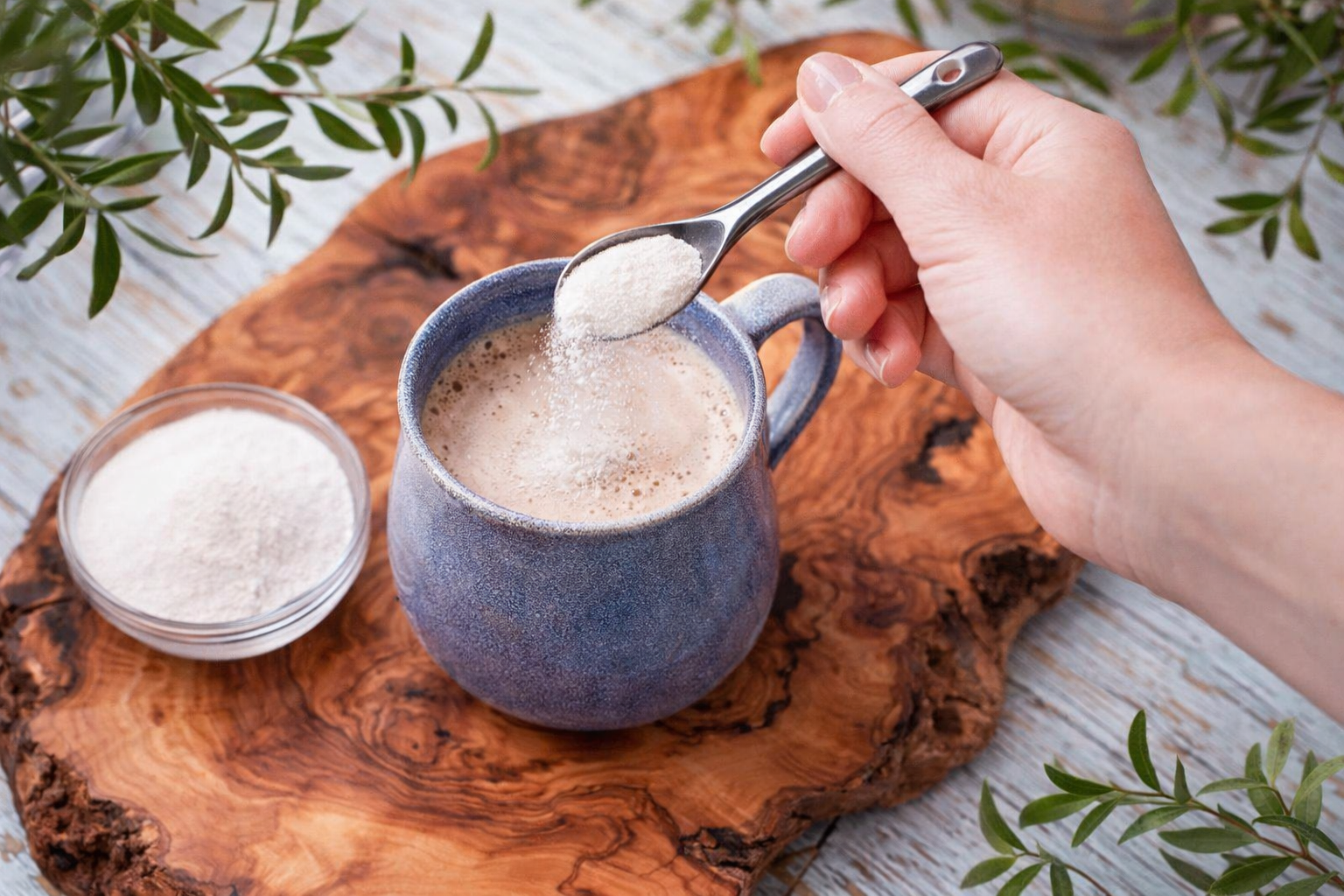 Collagen powder being added to coffee
